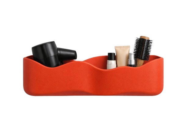 Red organizers holding a black hairdryer, lotion, hairbrush, and other hair care products.