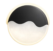 A circular plate with a black and white design resembling a stylized ocean wave.