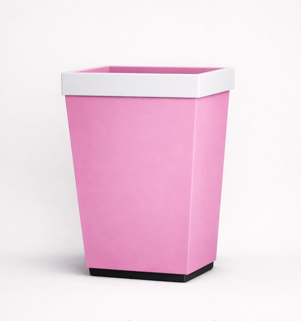 Pink and white laundry hamper against a white background.