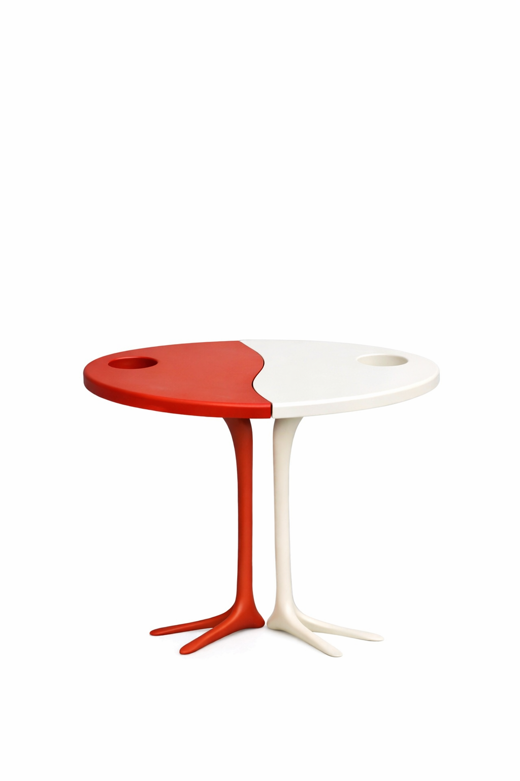 A uniquely designed table with a split top, half painted red and the other half painted white, resembling a yin-yang or a pair of intertwined legs.
