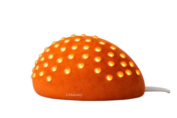 Orange object resembling a mushroom with yellow dots on top and a white cord on the right side.