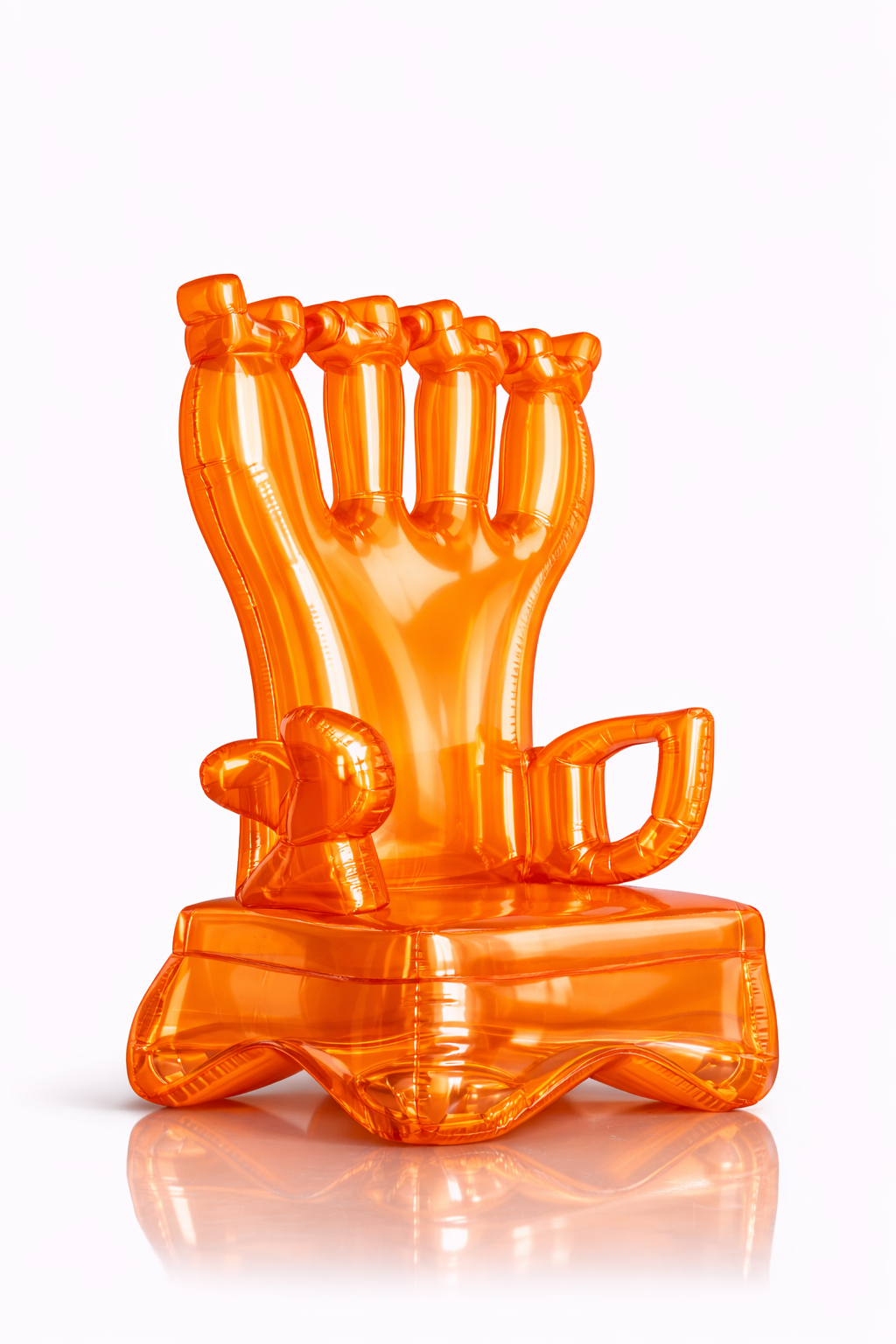 Orange inflatable balloon sculpture of a hand making a fist with a thumbs-up. The sculpture is on a rectangular base with a small balloon shaped like a fist next to the thumb.