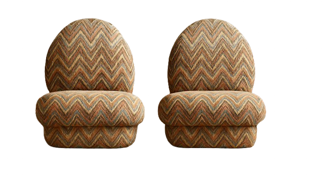 Two round upholstered chairs with multicolored zigzag pattern fabric, side by side, against a black background.