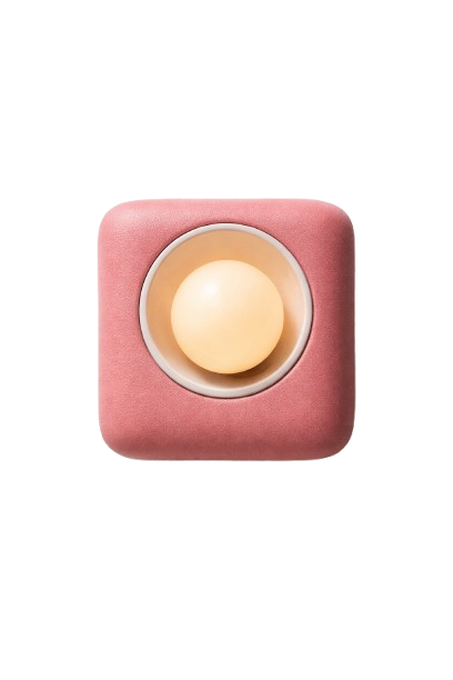 A pink square-shaped device with a circular button in the center, possibly a smart speaker or electronic gadget.