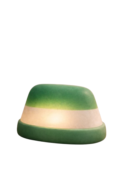 A green and beige product, possibly a personal care item or cosmetic container, with blurred text in the background