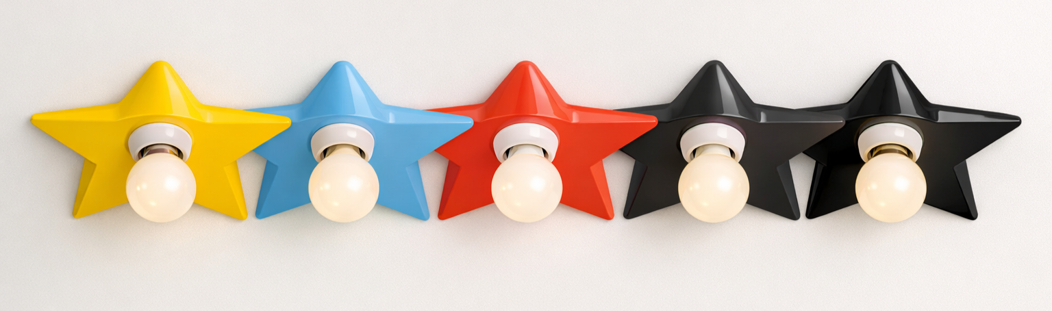 Five star-shaped wall light fixtures in yellow, blue, red, and black colors, each with a white light bulb in the center, mounted on a white wall.