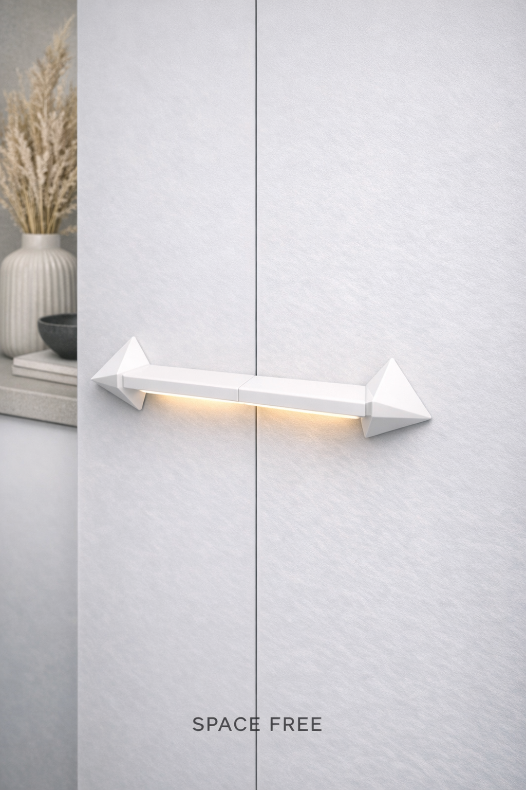 A modern white handle with downward lighting mounted on a white door with text 'SPACE FREE' at the bottom.