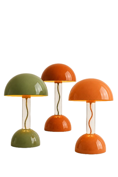 Three table lamps with round bases and domed shades, in green, orange, and tan, arranged on a white background. Distorted text in the background.