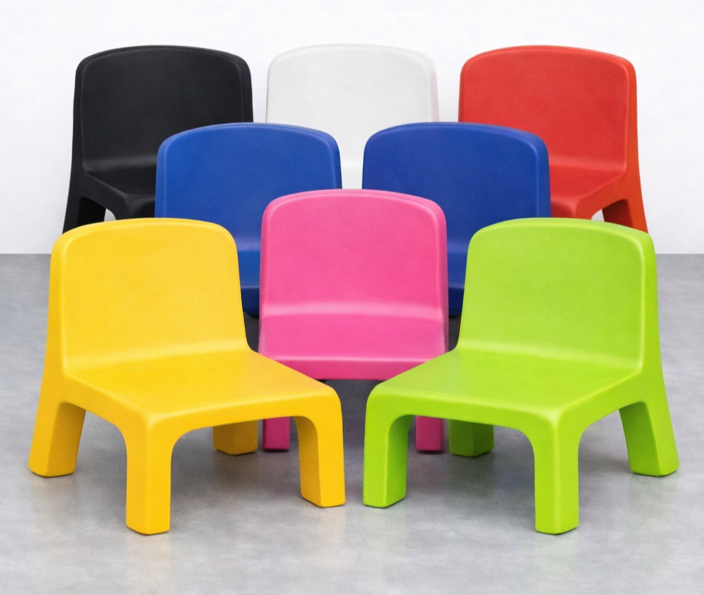 Colorful plastic chairs arranged in two rows on a gray floor, with black, white, red, blue, pink, and green chairs.