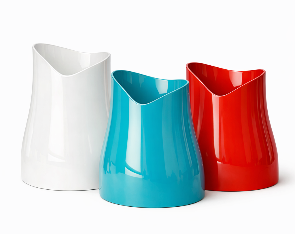 Three glossy vases in white, blue, and red, with curved, modern shapes, against a white background.