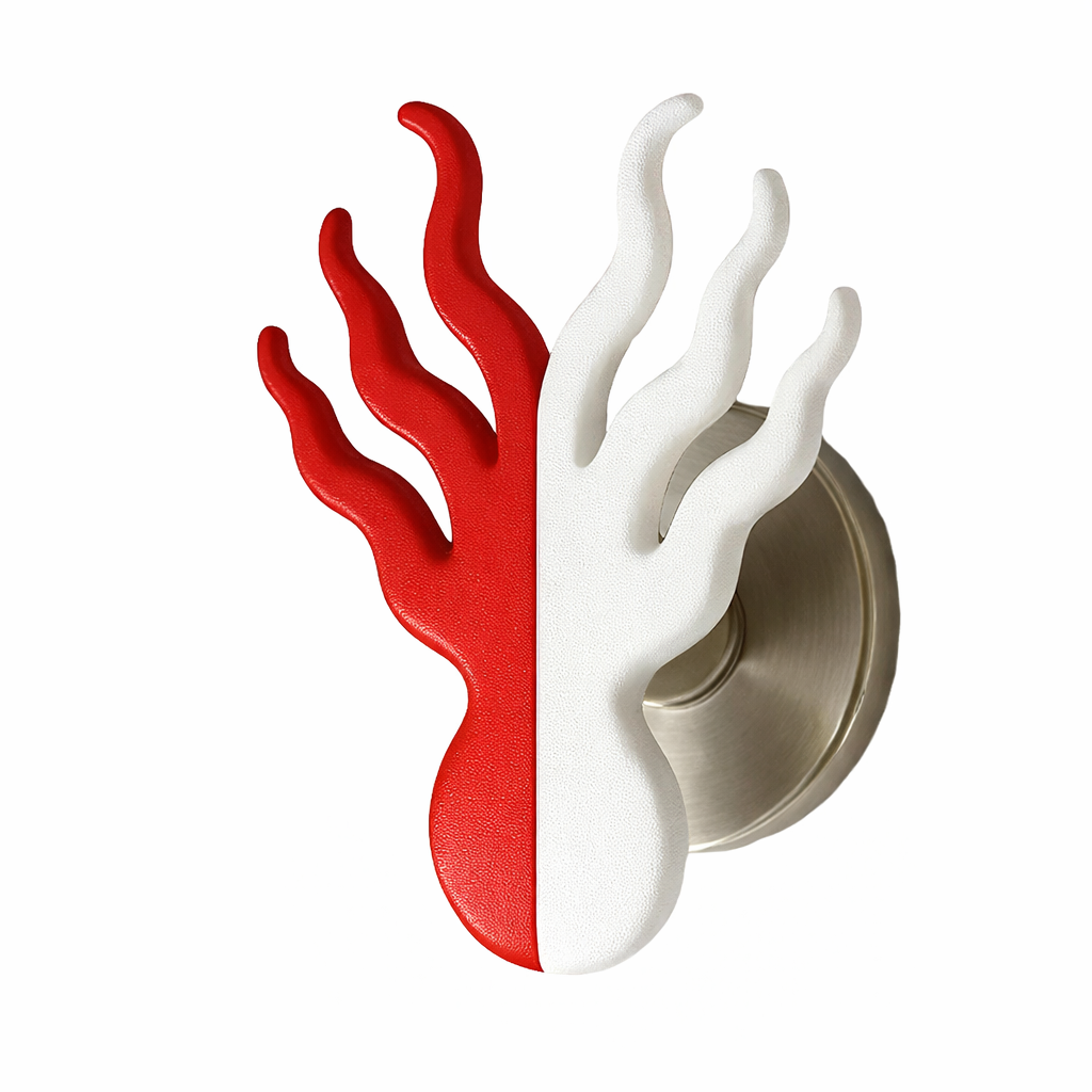 A door handle with a decorative design resembling flames, with half painted red and the other half painted white.