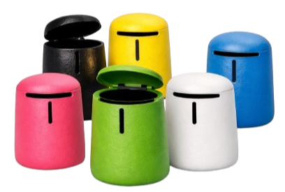 Colorful electronic singing toys resembling small drums with face-like features in black, yellow, blue, pink, green, and white.