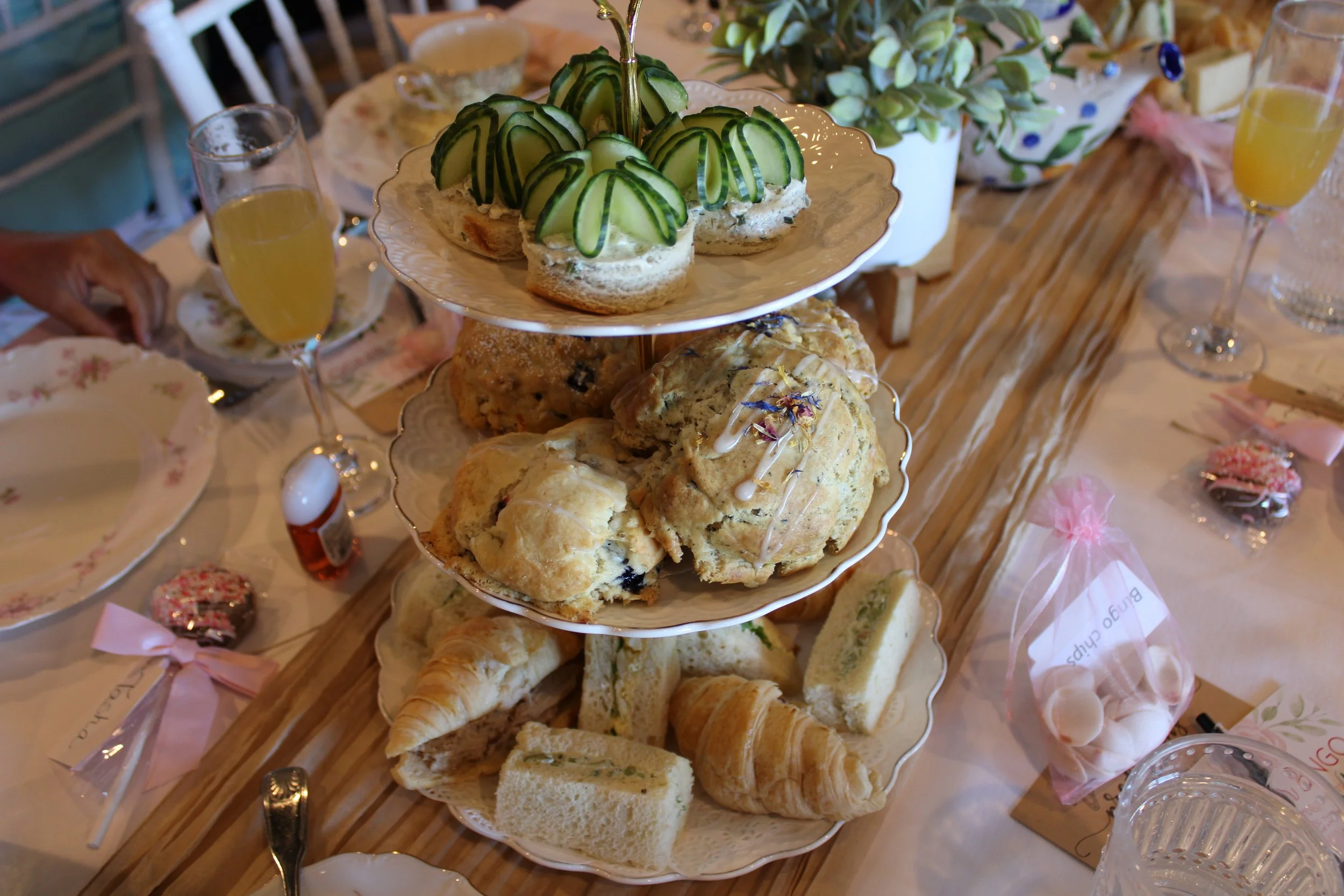 Three-tier afternoon tea stand with tea sandwiches, freshly baked scones and pastries at a baby shower held at Teapots & Treasures Café in Juno Beach, Florida.