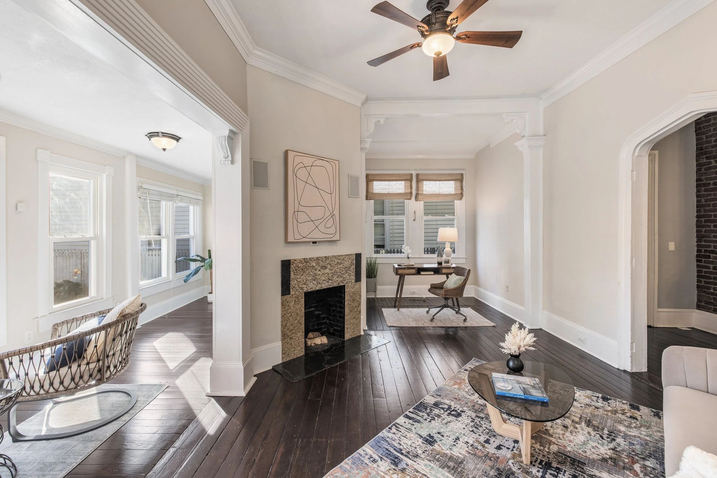 Large sunroom staged with connected living and office spaces