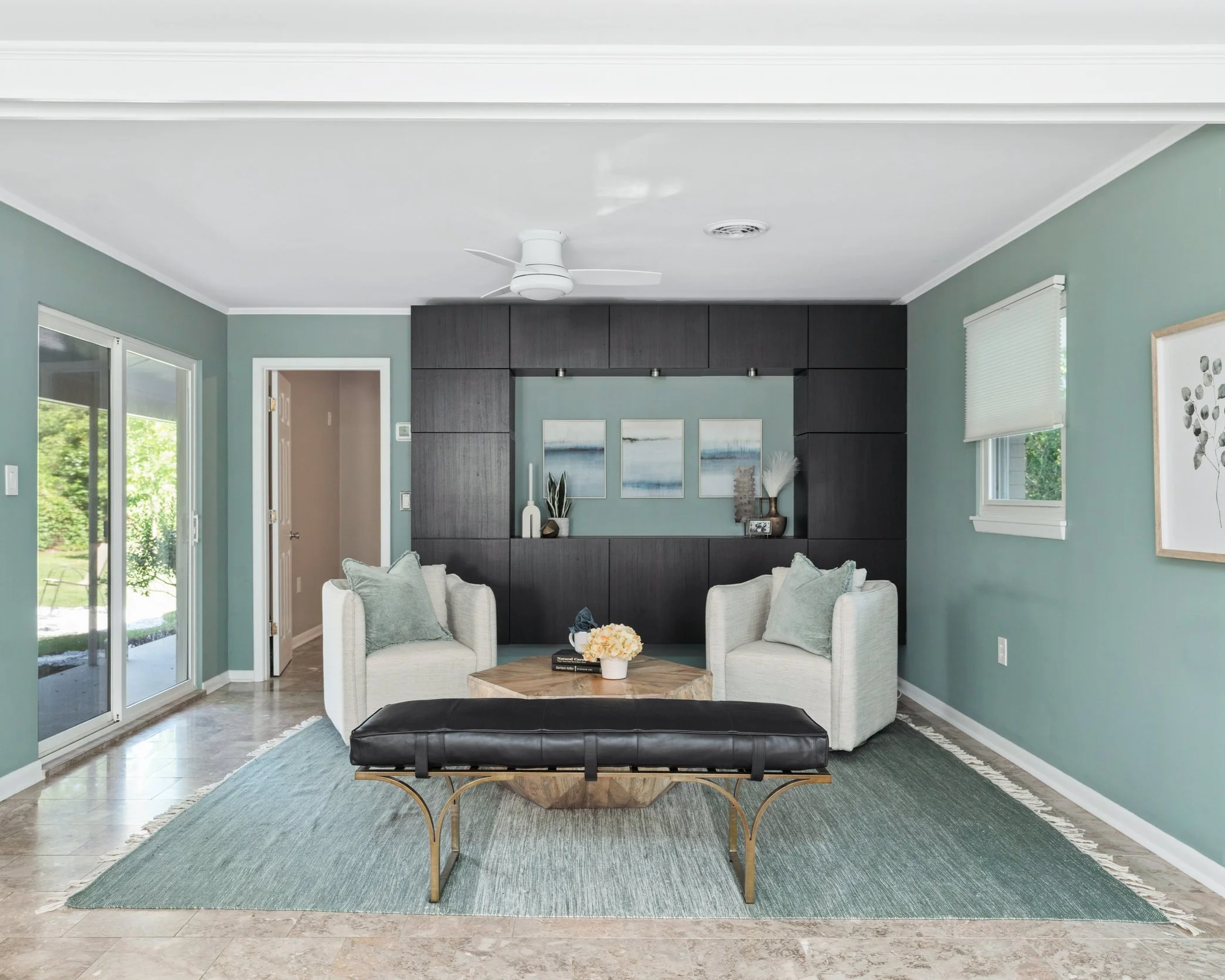 Muted blue-green living room with neutral furnishings and dark wood accents in Wilmington, NC