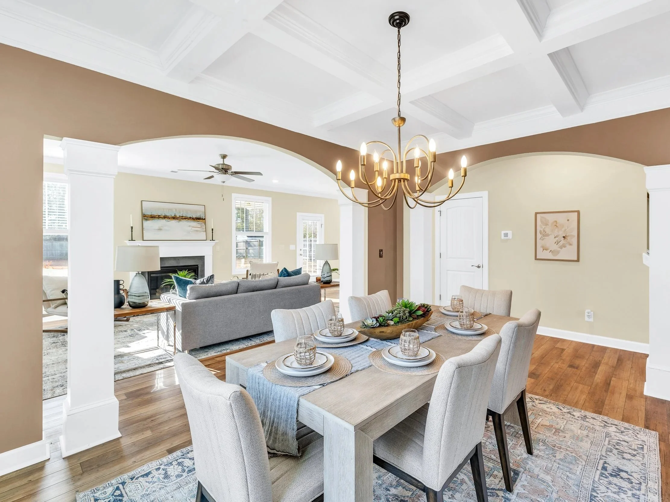 Warm taupe and neutral dining room with staged furnishings and cohesive color palette in Wilmington, NC