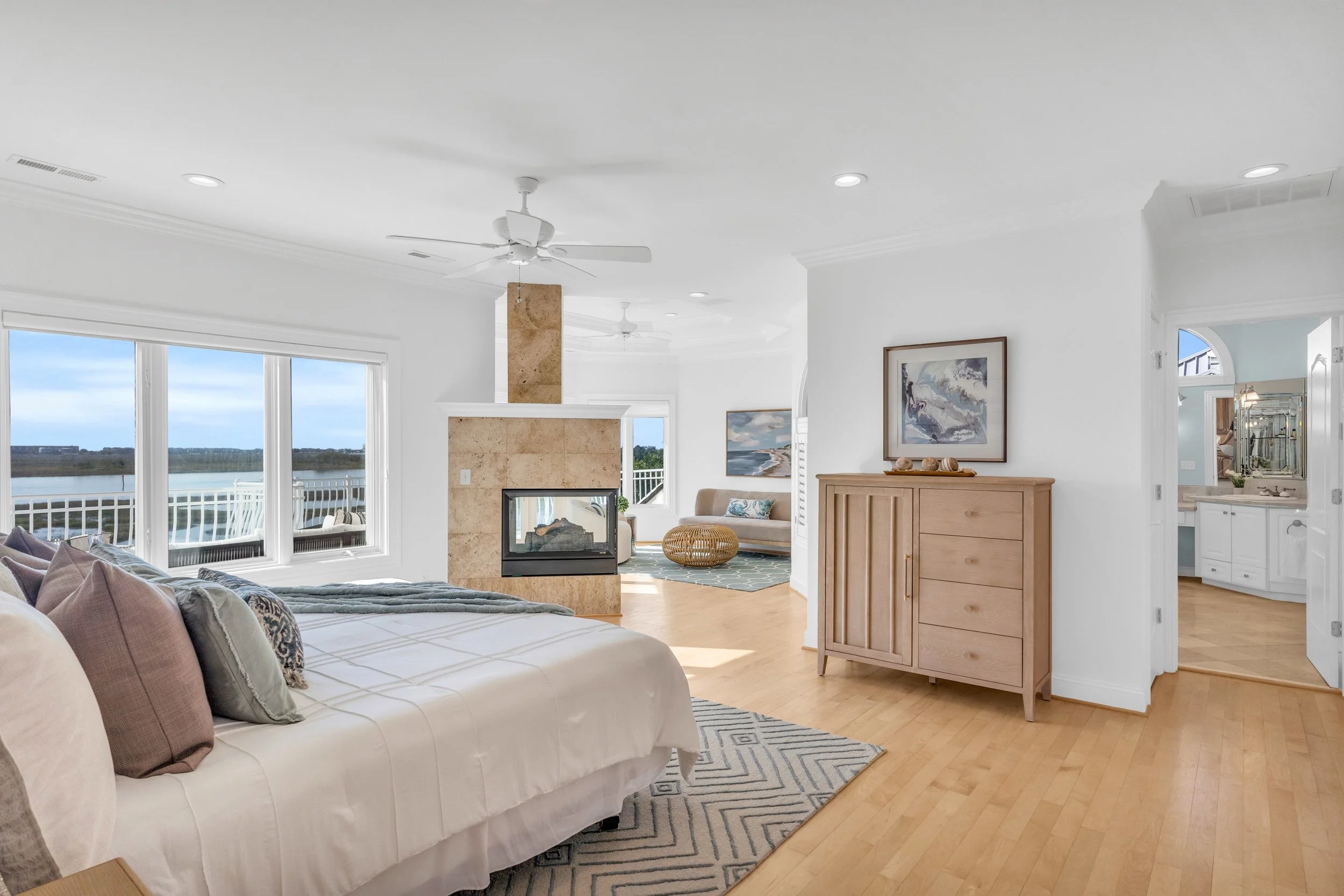 Large bedroom staged with a bed and separate sitting area
