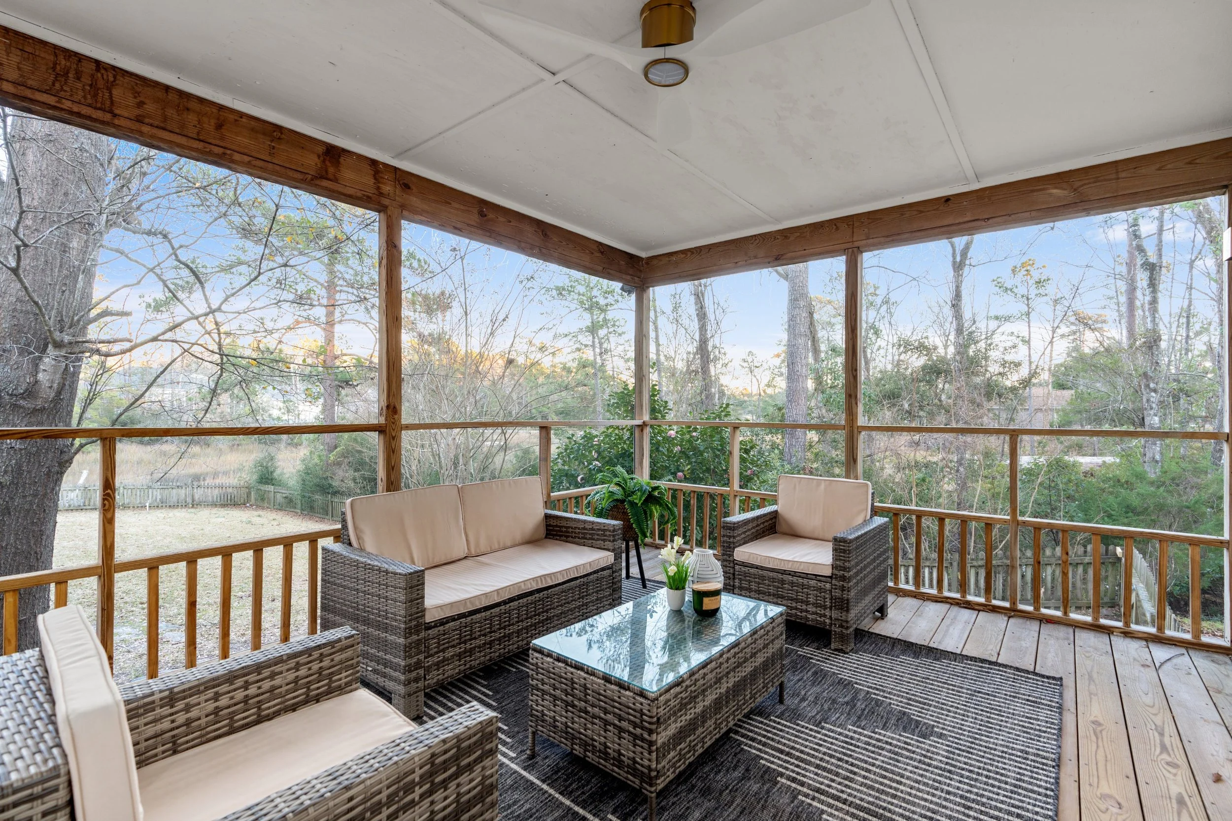 Staged screened porch with lounge area at a wilmington home for sale