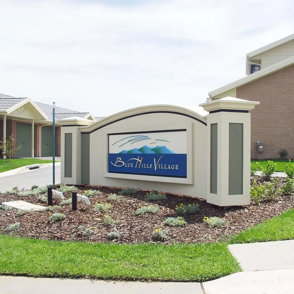 blue-hills-village-entrance-monument-aged-care-sign.webp