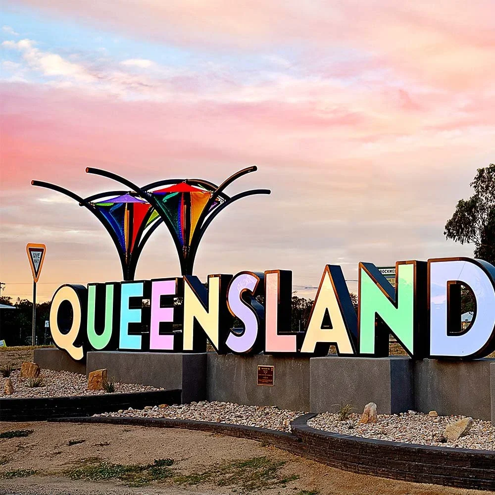 queenslander-gateway-sign-at-evening.webp