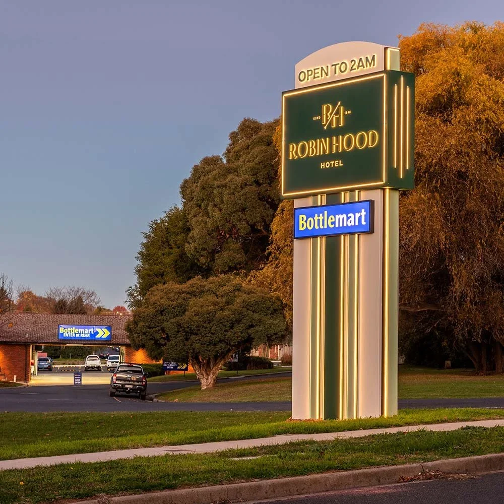 robin-hood-hotel-orange-custom-fabricated-illuminated-pylon-sign.webp