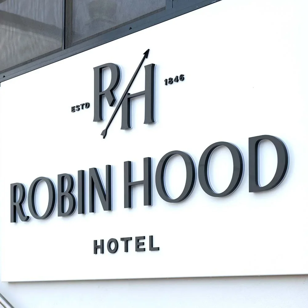 robin-hood-hotel-orange-illuminated-wall-letter-signage.webp