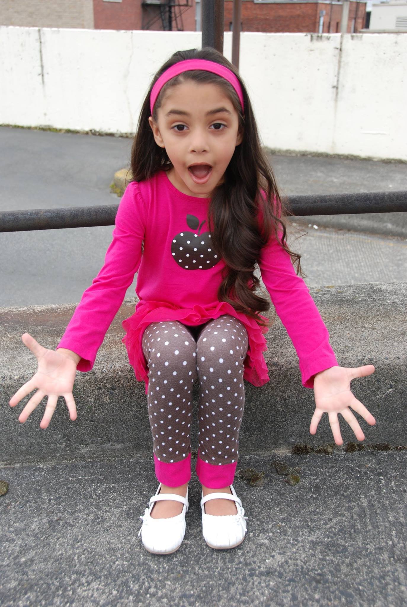 Child model in Seattle wearing a bright pink outfit during a youth talent development session at Talent USA.