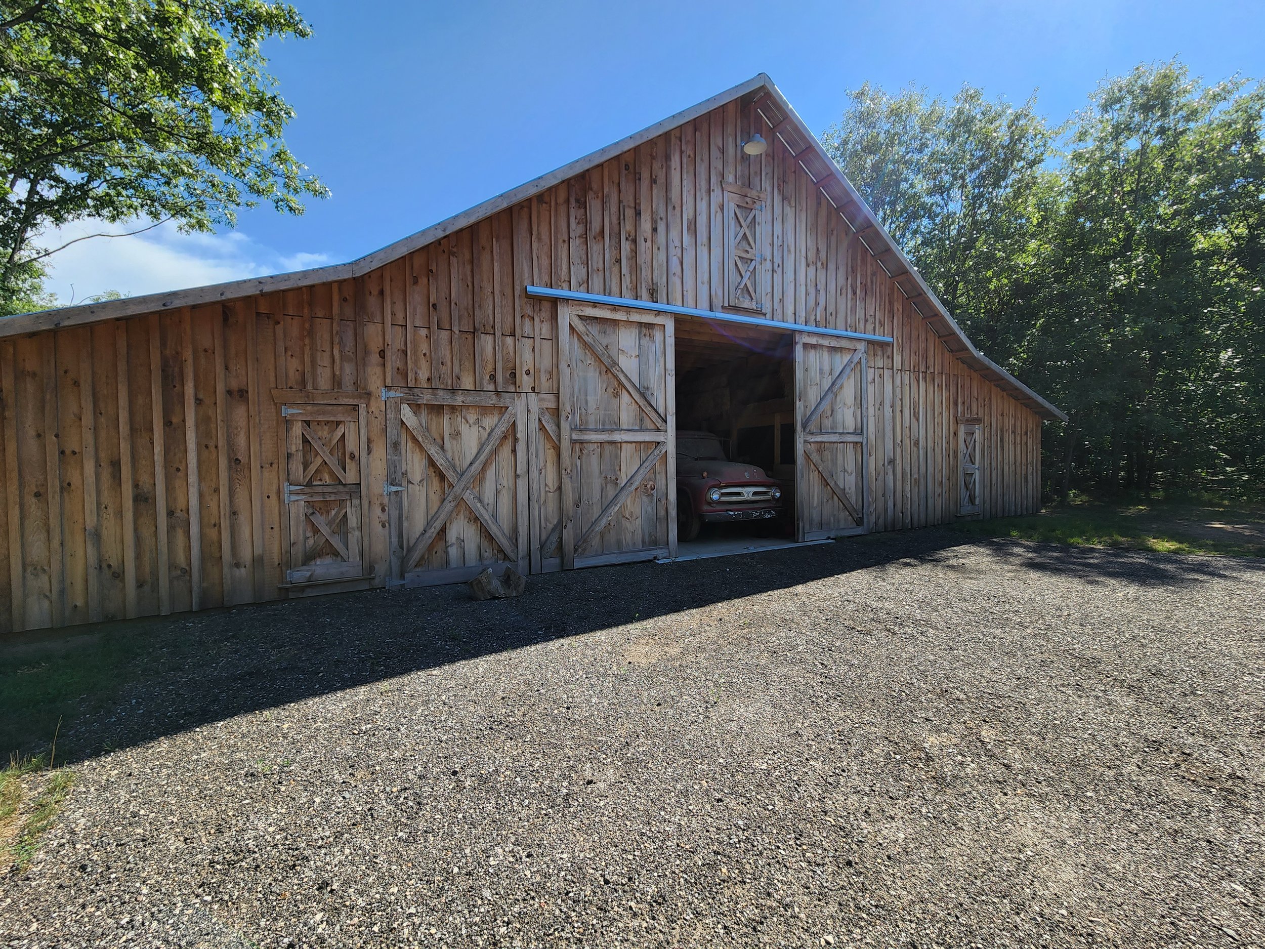A practical and stunning old fashioned livestock barn with 3 massive hayloft areas, built by Oakland Construction.