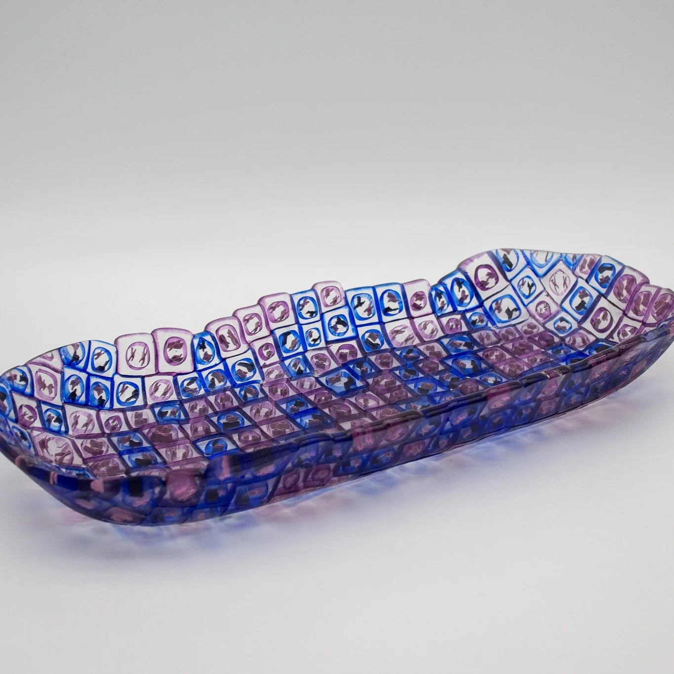 Chimerism
2025
Fused and slumped murrini
2.5 x 18 x 7.5 inches
*
Chimerism is a shallow glass platter made of XX and XY murrine cells in pink and blue, exploring chromosomal hybridity and the inherent queerness of the body. Biology doesn&rsquo;t dete