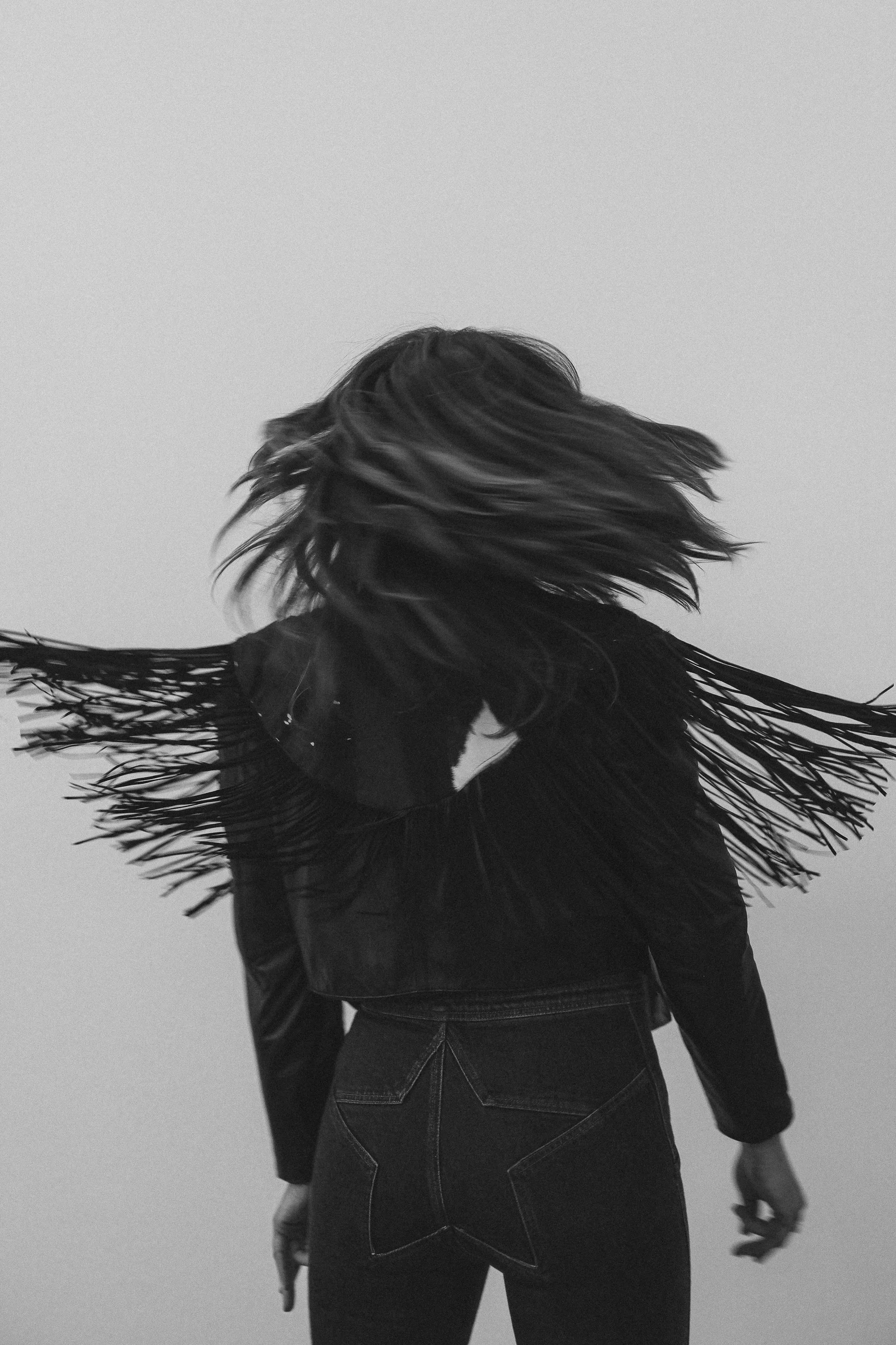 Kristin Thompson from behind with hair in motion, black and white.