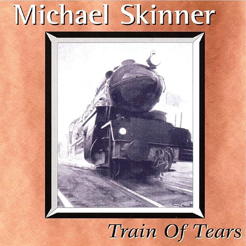 A black and white photo of a steam locomotive train on tracks, enclosed in a frame. The cover features the name 'Michael Skinner' at the top and the album title 'Train Of Tears' at the bottom.