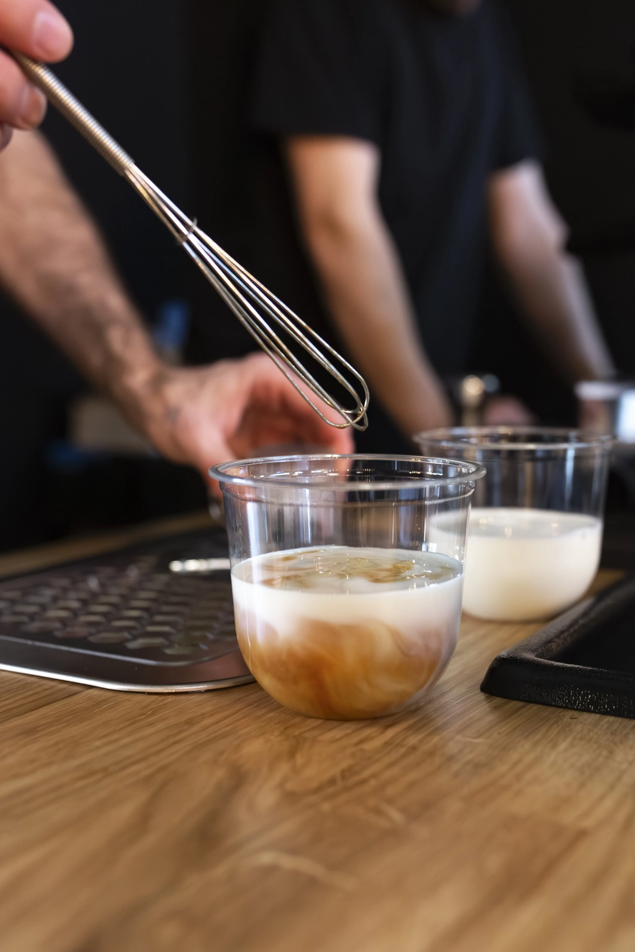 Stirring iced lattes at wedding on coffee cart.