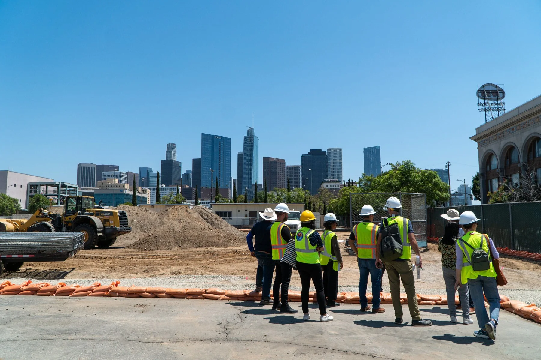 Photo of LANLT team and contractors in construction vests with the LA skyline as the background.
