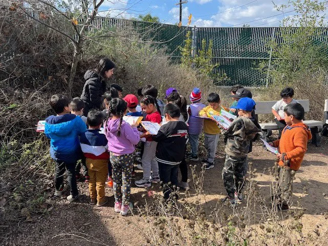 Photo of kids in the garden looking at worksheets