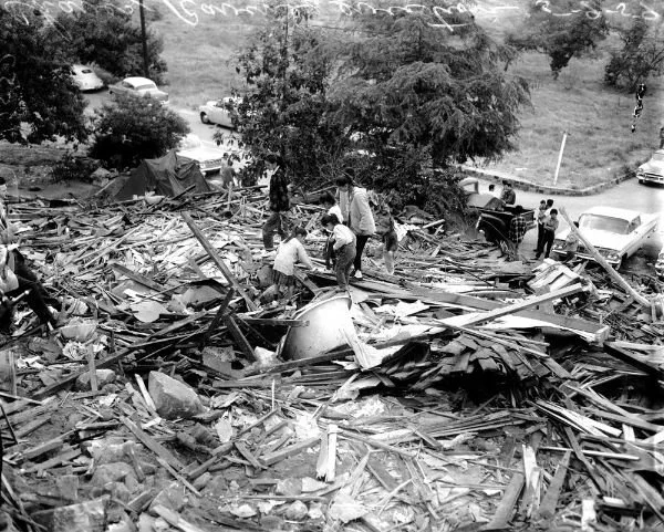 Photo of neighbors rummaging through rubble