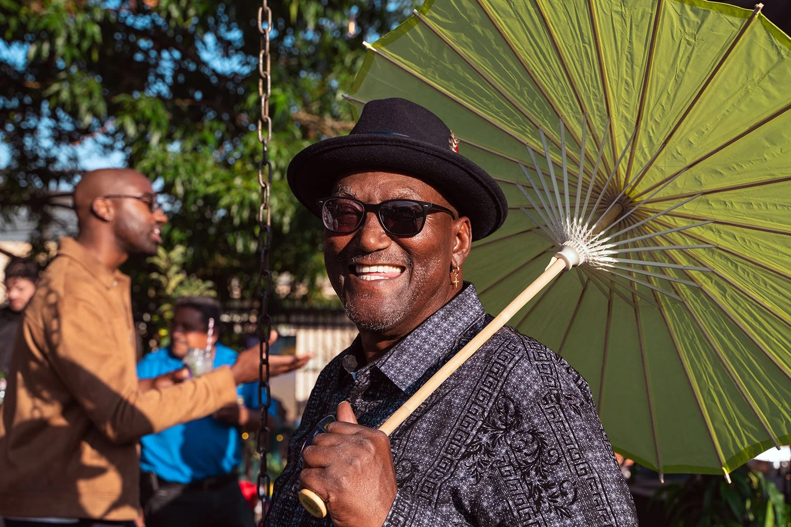 Photo of party attendee holding a green parasol