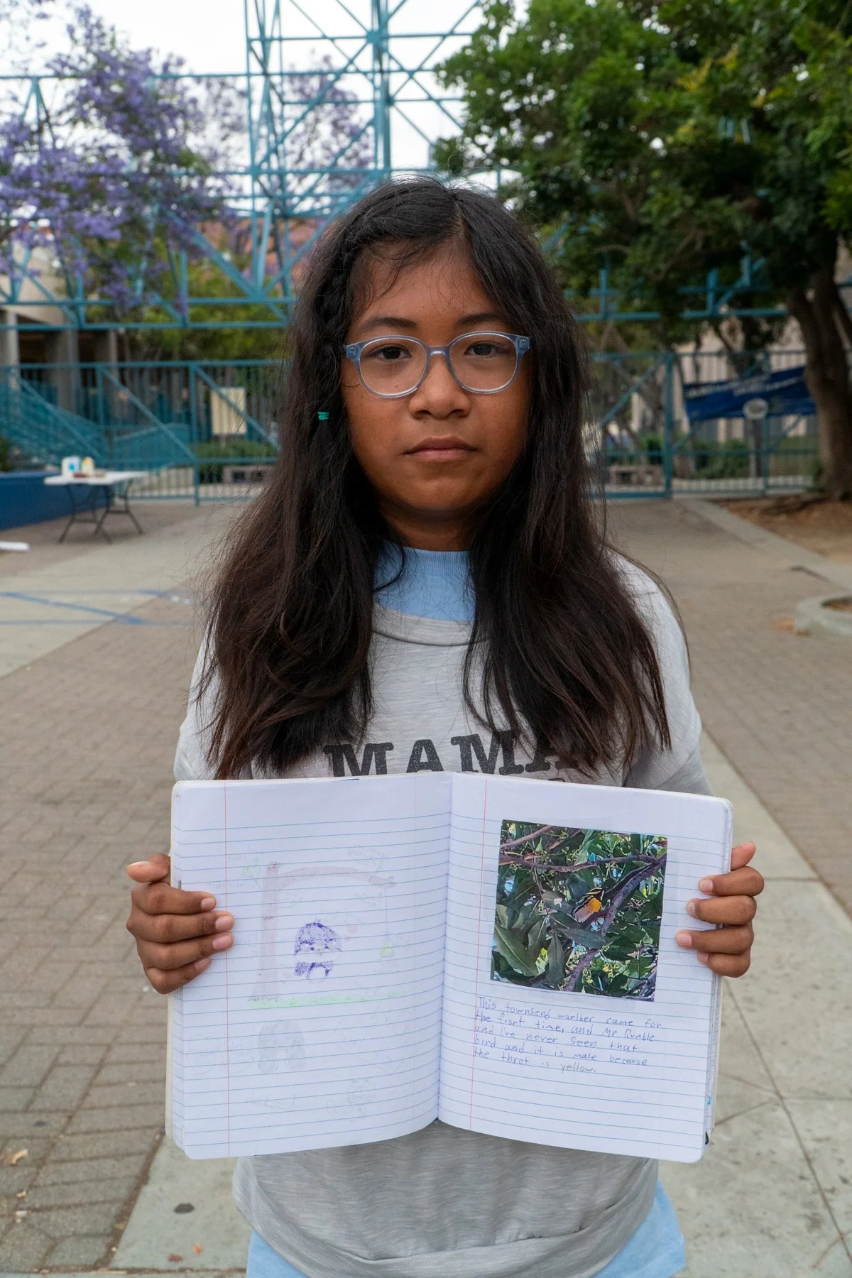 Photo of student holding up open notebook at Esperanza Elementary