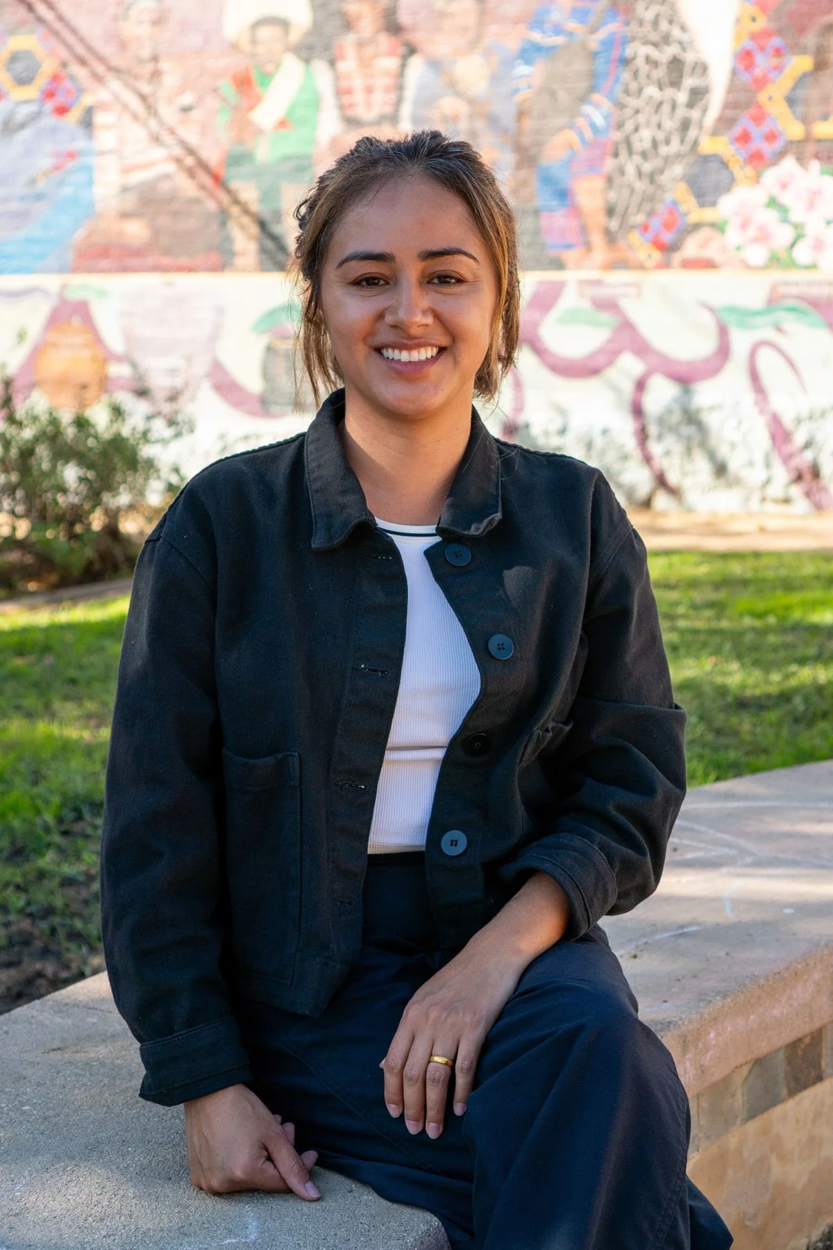 Photo of Adriana sitting in a park