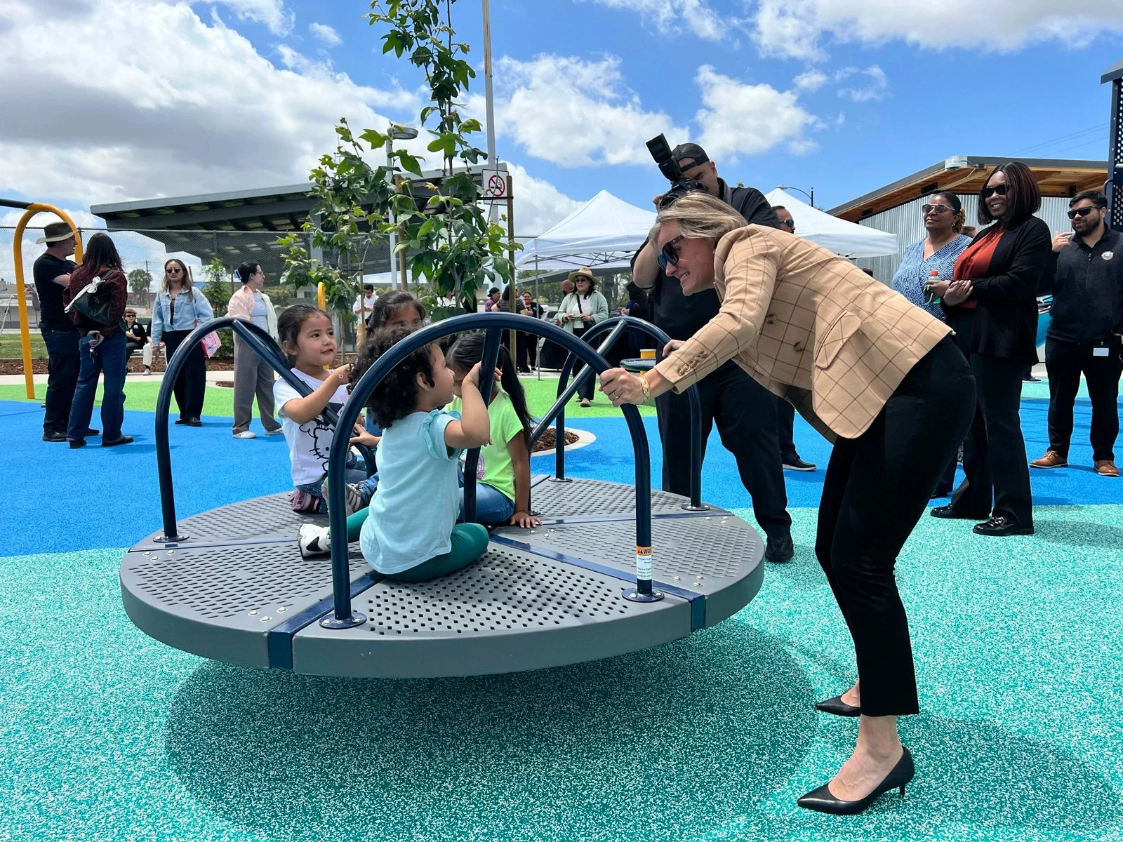 Photo of LANLT staff playing with kids at the playground