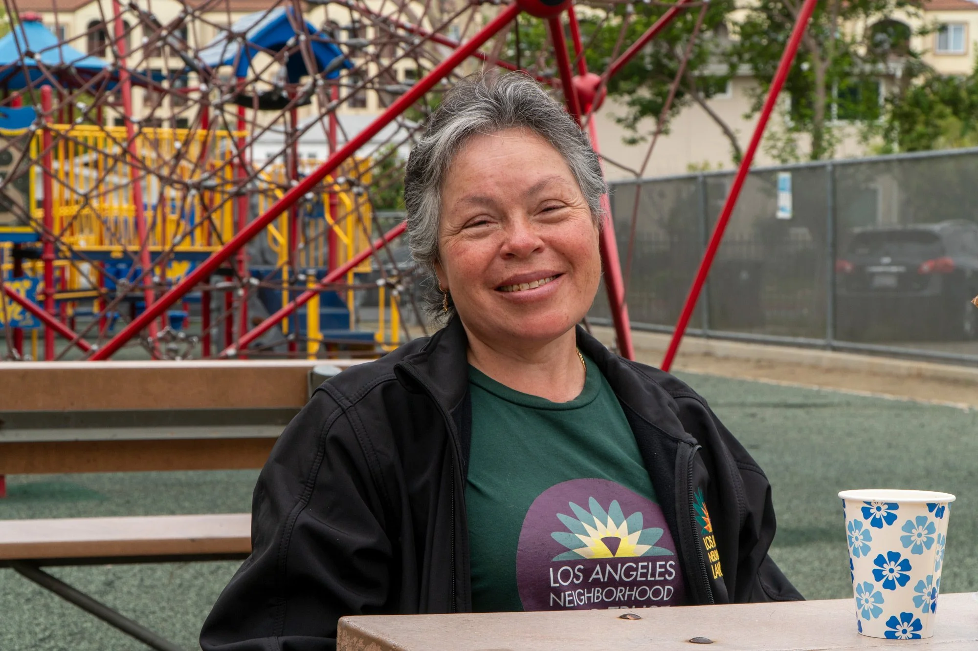 Photo of person smiling at a park table wearing a LANLT shirt