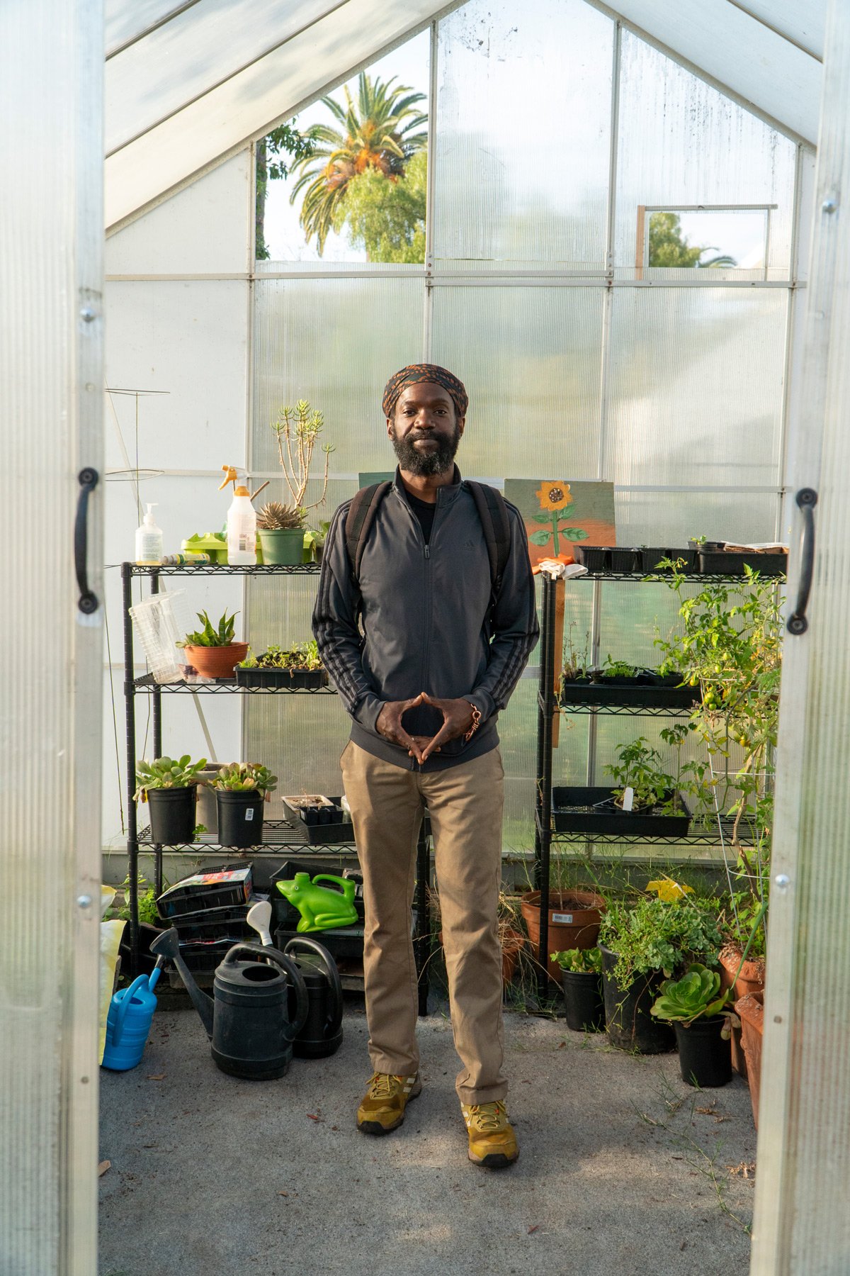 Photo of Chef Korby Benoit inside a green house