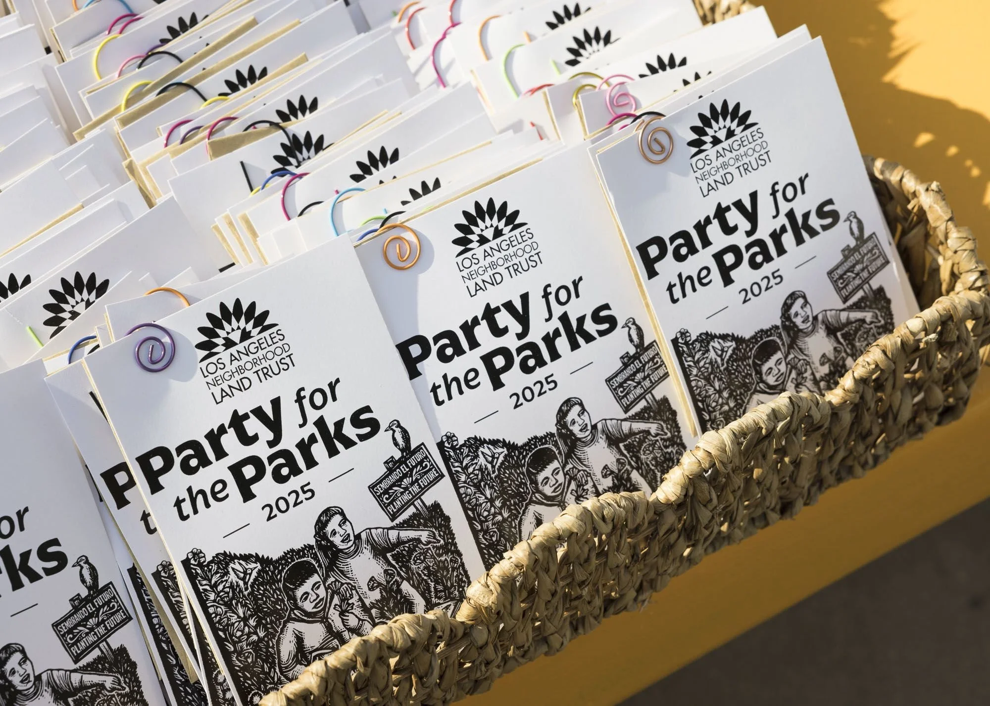 Photo of seed packets labeled Party for the Parks 2025 with the LANLT logo
