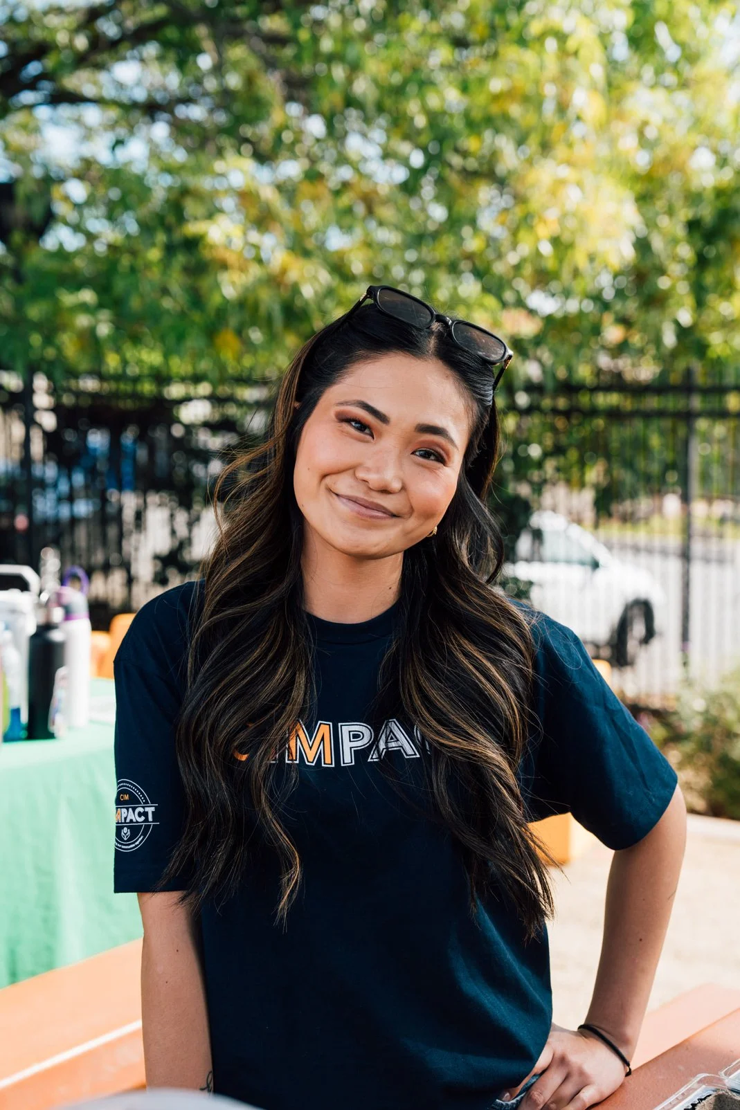 Photo of Sasha in the park wearing a CIMPACT shirt