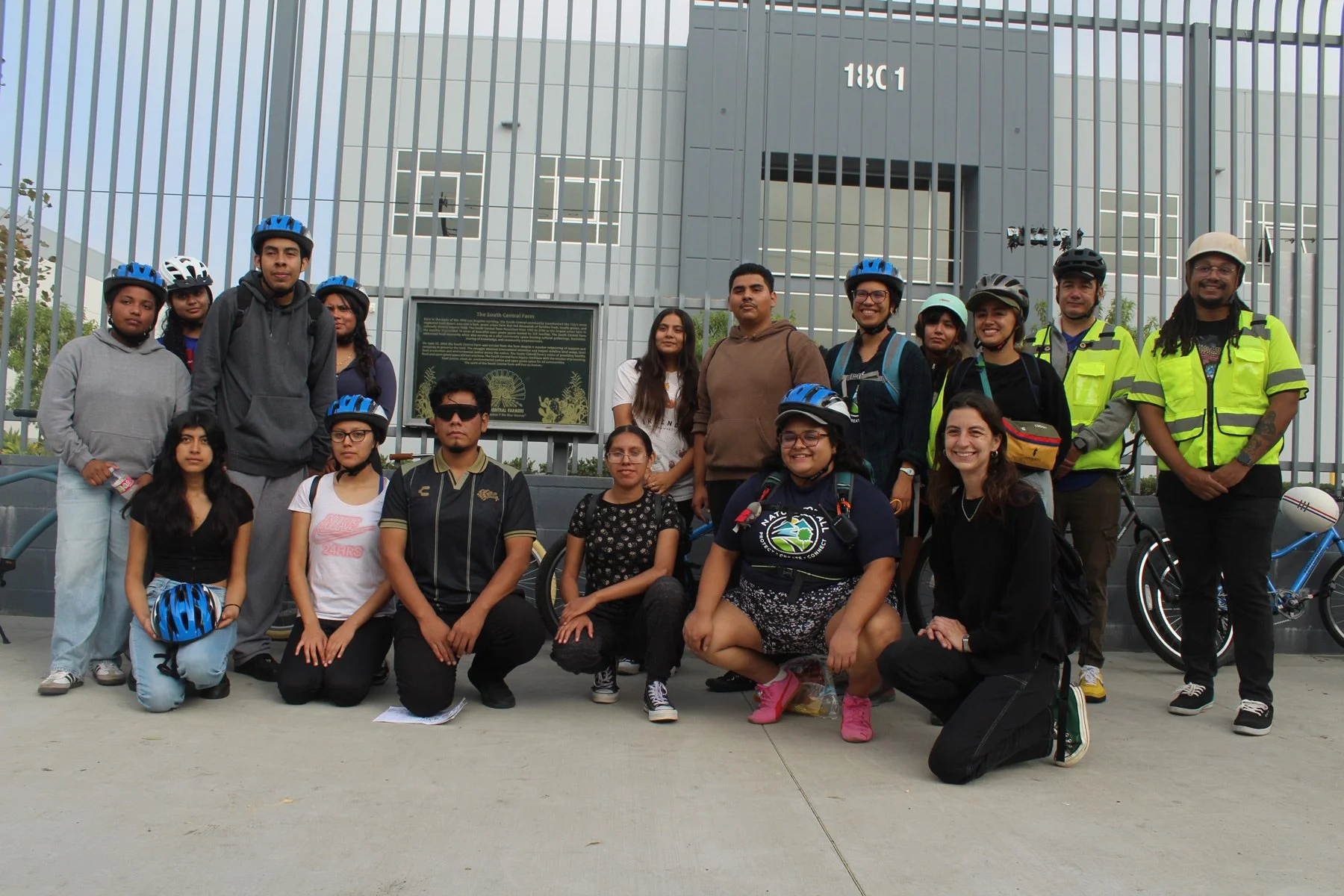 Photo of young people posing wearing bike helmets