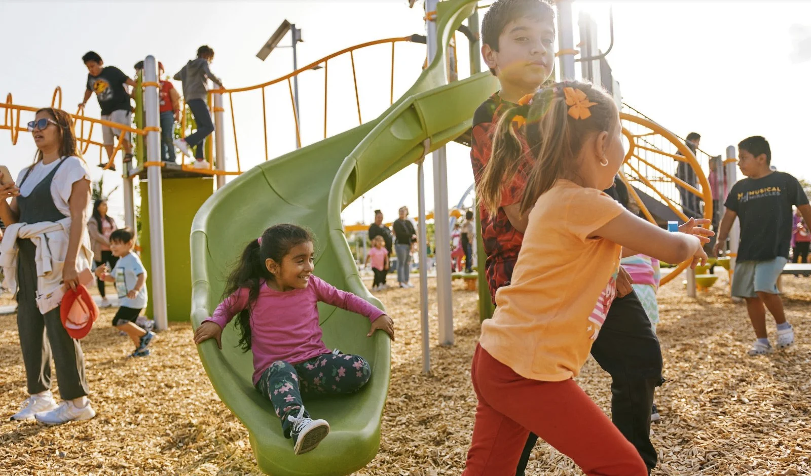 Children playing on a slide and playground