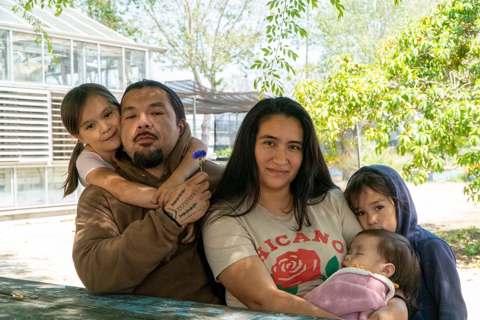 Photo of family sitting underneath a tree