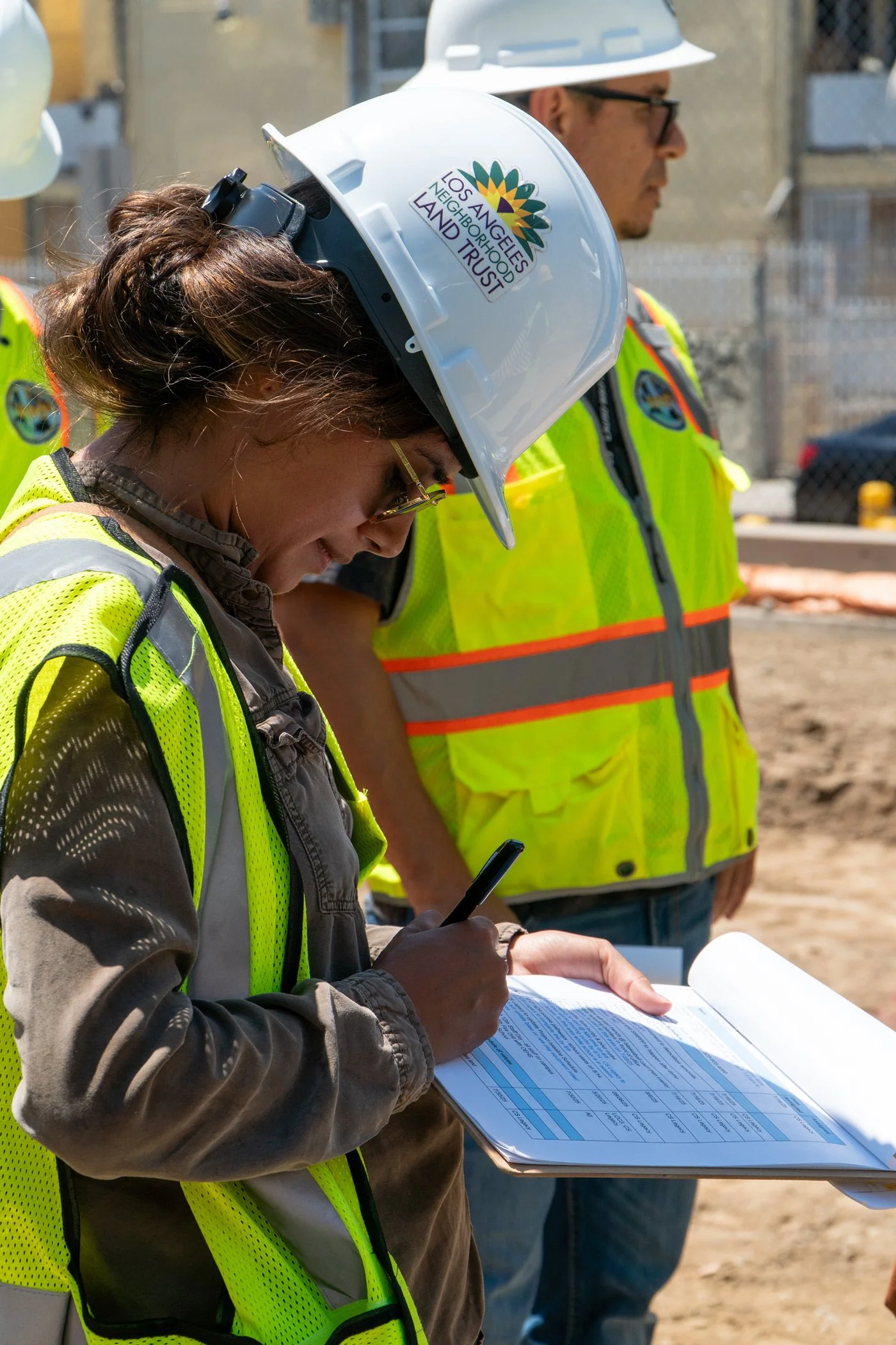 Photo of staff member at park construction site wearing construction hat with LANLT logo