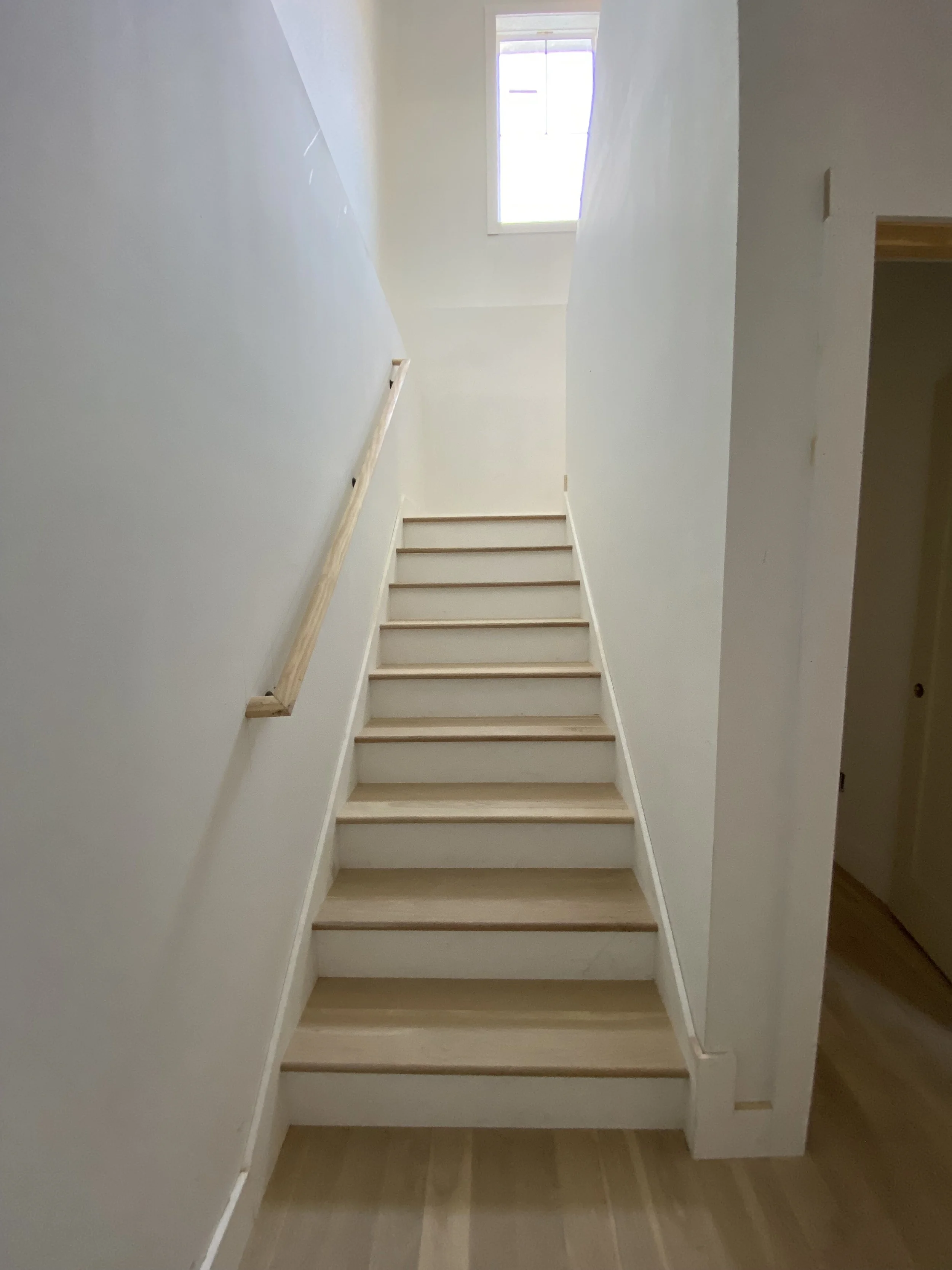 Staircase and windows in a custom home by Plumb Level Square in Leicester, NC 