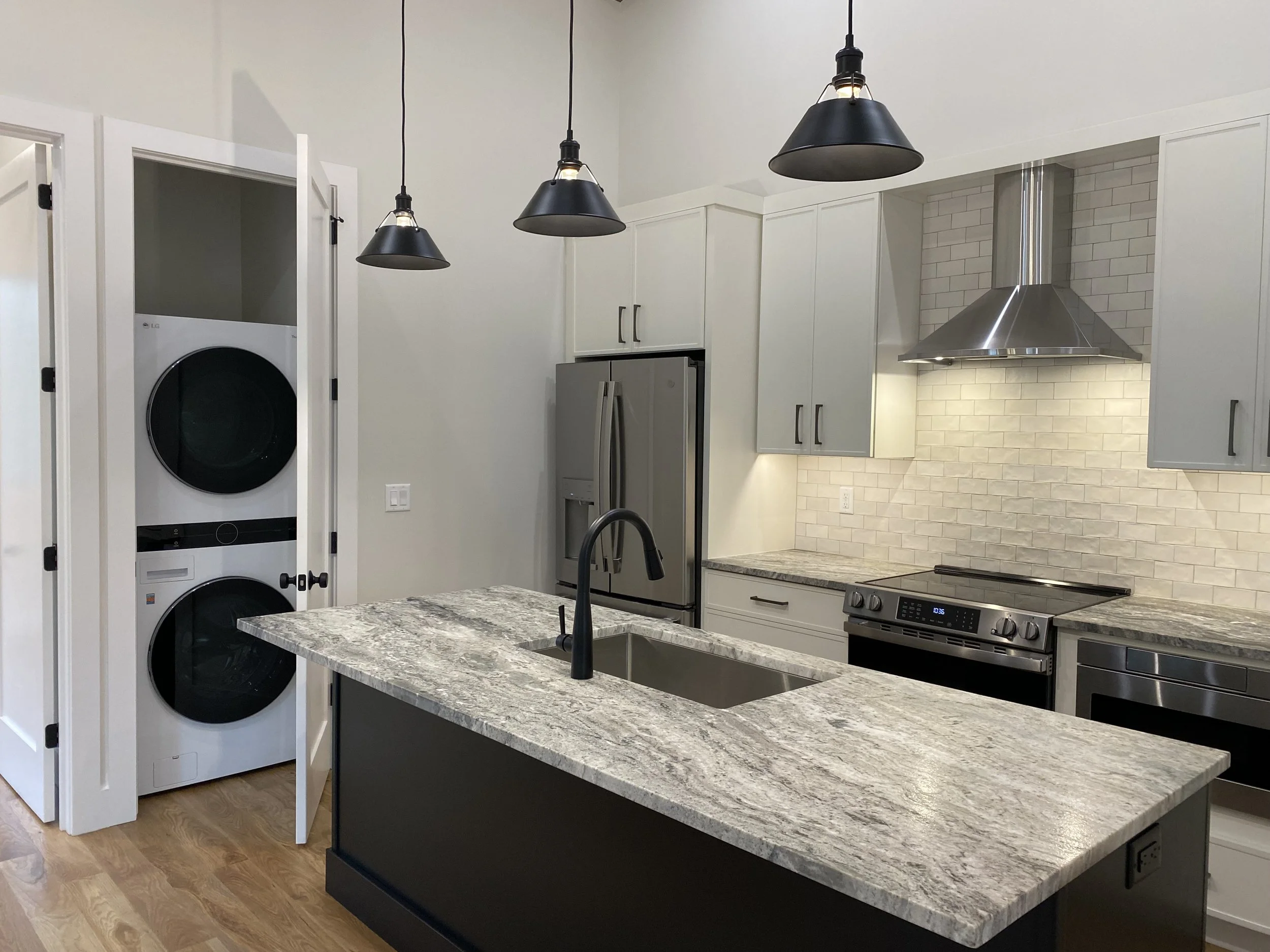 Functional laundry in a barndominium apartment by custom home builder Plumb Level Square in Wester North carolina 