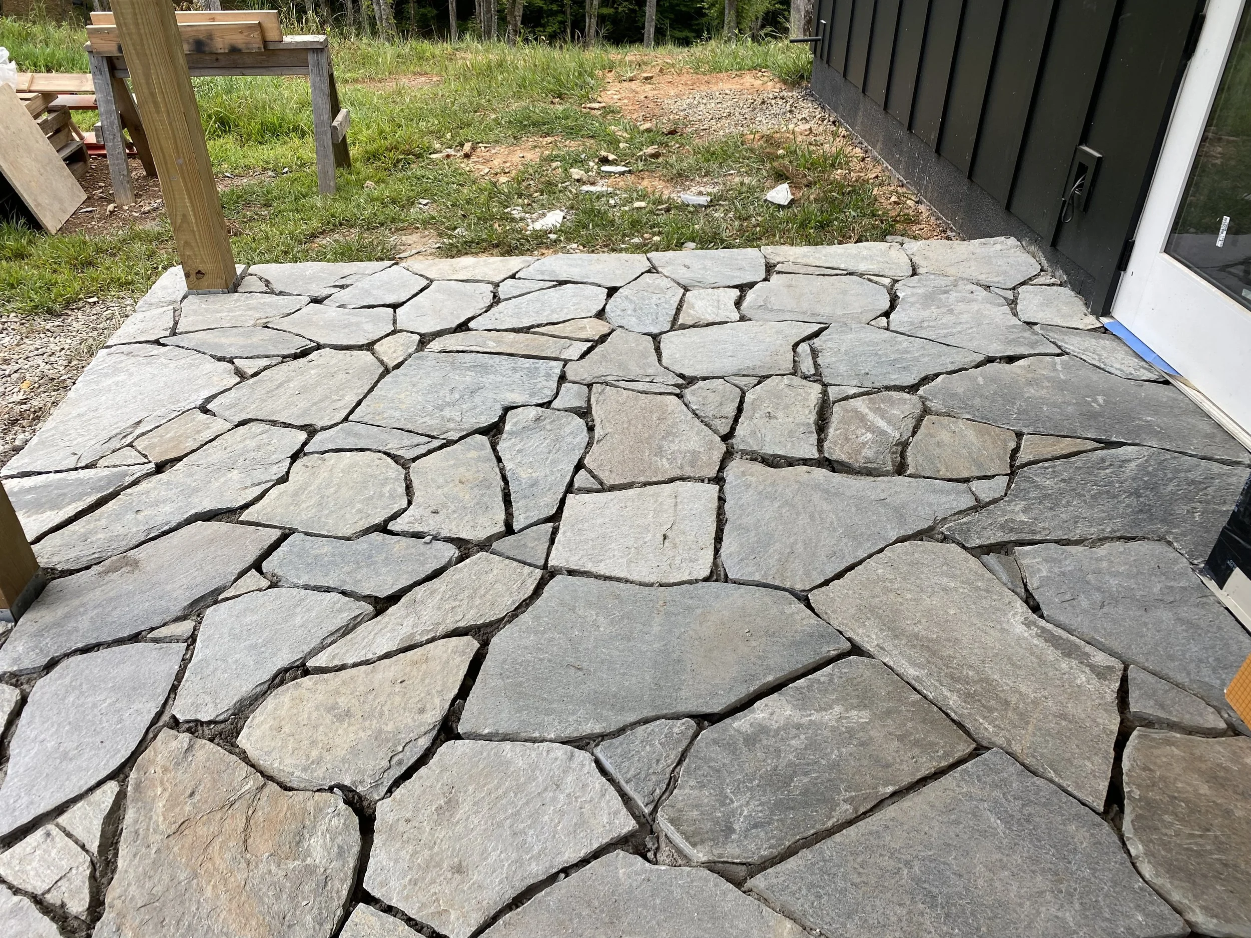 A newly constructed flagstone patio at the Barndominium built by Plumb Level Square in Madison County North Carolina 